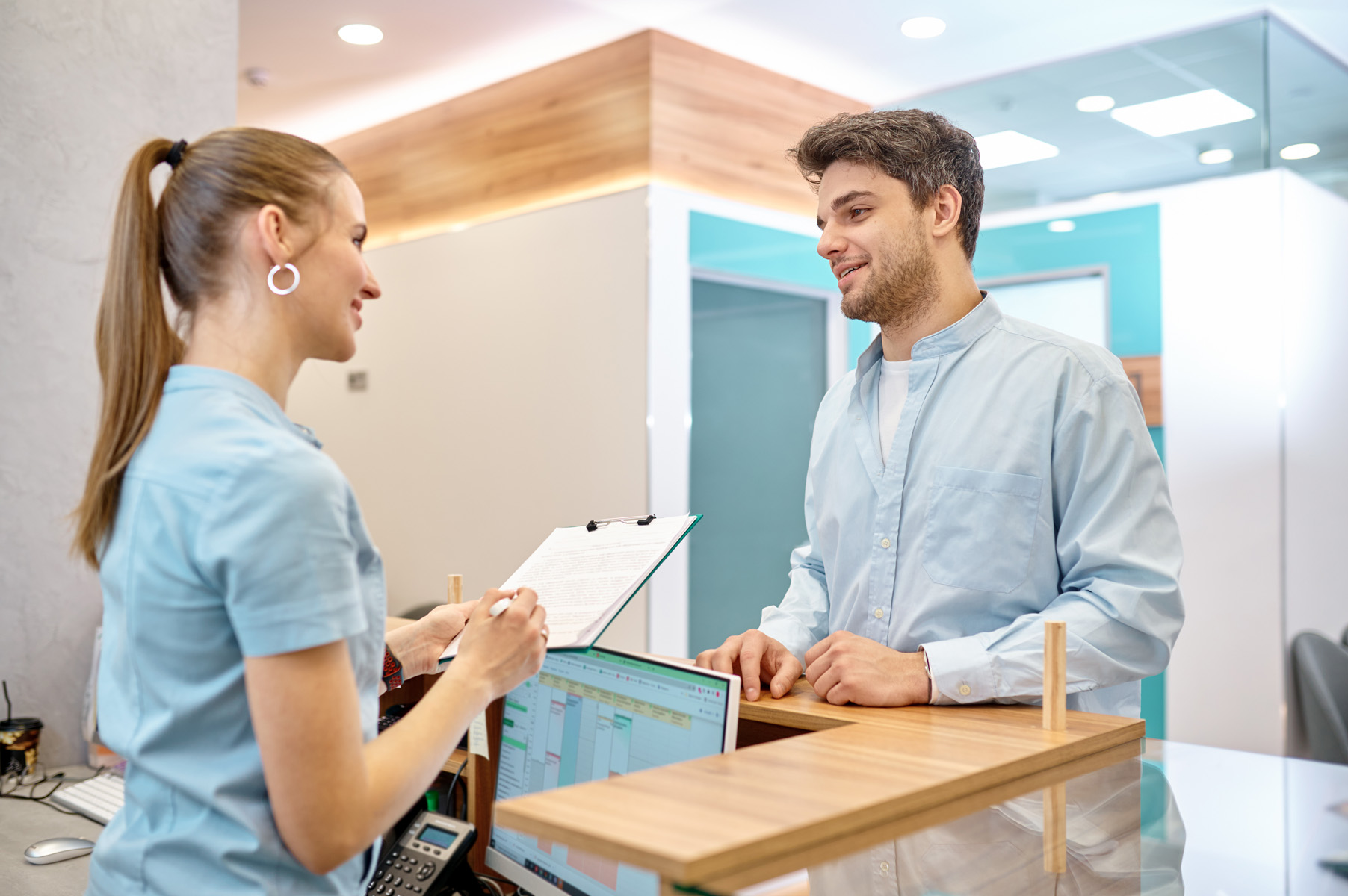 nurse and patient at reception desk
